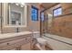 Well-lit bathroom features a granite countertop, framed mirror, and tiled shower at 6 Fire Rock Ct, Las Vegas, NV 89141