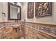 Cozy bathroom with travertine walls and mosaic tile accents at 6 Fire Rock Ct, Las Vegas, NV 89141