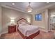 Beautiful bedroom featuring a plush bed, tray ceiling, and elegant lighting fixtures at 6 Fire Rock Ct, Las Vegas, NV 89141