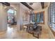 Second dining room boasts custom wood shutters, beamed ceilings, and an elegant chandelier lighting at 6 Fire Rock Ct, Las Vegas, NV 89141