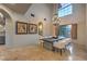 Bright dining room features a large window, striking chandelier and a rustic wood table with seating for eight at 6 Fire Rock Ct, Las Vegas, NV 89141