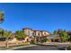 Upscale stucco home featuring a turret, tile roof, and manicured landscaping in a luxury neighborhood at 6 Fire Rock Ct, Las Vegas, NV 89141