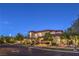 Elegant stucco and stone home with manicured landscaping and a tile roof, illuminated at dusk at 6 Fire Rock Ct, Las Vegas, NV 89141