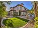 Stunning home exterior boasts a manicured lawn, stone columns, and a poolside pergola at 6 Fire Rock Ct, Las Vegas, NV 89141