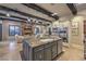 Open-concept kitchen with a large island, dark wood beams and flows into a cozy living room with a fireplace at 6 Fire Rock Ct, Las Vegas, NV 89141