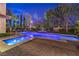 Beautifully lit pool area with water fountains and brick paving under a night sky at 6 Fire Rock Ct, Las Vegas, NV 89141