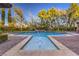 Luxurious pool with water features surrounded by lush greenery and brick patio at 6 Fire Rock Ct, Las Vegas, NV 89141