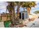 Enclosed backyard featuring mature palm trees, a small garden shed, and hardscape at 6202 La Palma Pkwy, Las Vegas, NV 89118