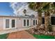 Exterior view of the rear of the home, featuring mature palm trees at 6202 La Palma Pkwy, Las Vegas, NV 89118