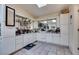 Bonus room featuring white cabinets, a mirrored backsplash, tiled floors, and natural light at 6202 La Palma Pkwy, Las Vegas, NV 89118