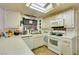 Functional kitchen features white appliances, tile floors and plenty of counter space at 6202 La Palma Pkwy, Las Vegas, NV 89118