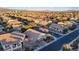 High-angle view showcases houses in a residential area, displaying community layout with city skyline afar at 6944 Puetollano Dr, North Las Vegas, NV 89084