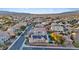 Scenic overhead shot showcases a neighborhood with houses that have solar panels, and a backyard pool at 6944 Puetollano Dr, North Las Vegas, NV 89084