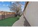 A beautiful backyard featuring green grass, an enclosed garden, and rock features at 6944 Puetollano Dr, North Las Vegas, NV 89084