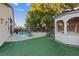 A backyard features an in-ground pool, a hot tub, and a shaded gazebo at 6944 Puetollano Dr, North Las Vegas, NV 89084