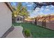 Backyard featuring green grass, a gazebo, and secure fence at 6944 Puetollano Dr, North Las Vegas, NV 89084