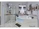 A modern bathroom featuring a soaking tub, shower and updated fixtures, with tiled walls and natural light at 6944 Puetollano Dr, North Las Vegas, NV 89084