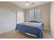 Cozy bedroom featuring carpet, a large window with blinds, and closet at 6944 Puetollano Dr, North Las Vegas, NV 89084