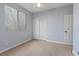 Bedroom with neutral walls, carpet, large window with blinds and closet at 6944 Puetollano Dr, North Las Vegas, NV 89084