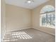 Bright, carpeted bedroom with natural light, a ceiling fan, and a large window at 6944 Puetollano Dr, North Las Vegas, NV 89084