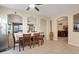 Open dining room featuring tile flooring, a ceiling fan, and backyard views at 6944 Puetollano Dr, North Las Vegas, NV 89084