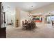 A formal dining room featuring an ornate chandelier, seating for eight, and easy access to the kitchen at 6944 Puetollano Dr, North Las Vegas, NV 89084