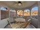 A cozy gazebo with a ceiling fan and wooden chairs around an octagonal table at 6944 Puetollano Dr, North Las Vegas, NV 89084