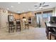 Well-lit kitchen featuring an island, stainless steel appliances, and light wood cabinets at 6944 Puetollano Dr, North Las Vegas, NV 89084