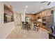 Open kitchen featuring a breakfast bar, stainless steel appliances, and tile flooring at 6944 Puetollano Dr, North Las Vegas, NV 89084