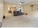 Cozy living room features neutral paint, carpet flooring, and natural light at 6944 Puetollano Dr, North Las Vegas, NV 89084