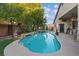 Inviting backyard swimming pool with rock accents and easy access to home, great for relaxation and fun at 6944 Puetollano Dr, North Las Vegas, NV 89084