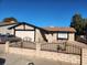 Street view of a single-story house with a white garage door and desert landscaping at 7176 Southpark Ct, Las Vegas, NV 89147