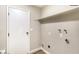 Simple utility area with a door, shelf, and hook-ups at 7176 Southpark Ct, Las Vegas, NV 89147