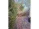 View of a cozy brick-paved backyard patio with potted plants and greenery at 7186 Cressida Ct, Las Vegas, NV 89113