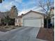 Traditional home featuring a red tile roof and an attached two-car garage at 7186 Cressida Ct, Las Vegas, NV 89113