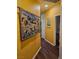 Hallway with hardwood floors and sunflower tapestry on the wall at 7186 Cressida Ct, Las Vegas, NV 89113