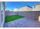 Private backyard with brick patio and artificial turf at 7246 Copper Grove Ave, Las Vegas, NV 89113