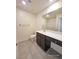 Well-lit bathroom featuring a large vanity and tile flooring at 7246 Copper Grove Ave, Las Vegas, NV 89113