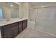 Bright bathroom with double sinks and a large glass shower enclosure at 7246 Copper Grove Ave, Las Vegas, NV 89113