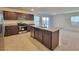 Modern kitchen with stainless steel appliances, granite countertops, and an island with a sink at 7246 Copper Grove Ave, Las Vegas, NV 89113