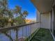 Balcony view overlooking trees, street, and distant mountains with artificial turf at 725 N Royal Crest Cir # 213, Las Vegas, NV 89169
