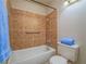 Bathroom featuring accessible tub with tiled surround and safety bar at 725 N Royal Crest Cir # 213, Las Vegas, NV 89169