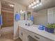 Clean bathroom featuring a wide vanity, a decorative mirror and tiled shower at 725 N Royal Crest Cir # 213, Las Vegas, NV 89169