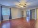 Bright bedroom with wood floors, ceiling fan, and large mirrored closet at 725 N Royal Crest Cir # 213, Las Vegas, NV 89169