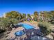 Aerial view of community pool and jacuzzi with lounge chairs and mature landscaping at 725 N Royal Crest Cir # 213, Las Vegas, NV 89169