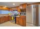 Traditional kitchen with stainless steel appliances, dark cabinetry, and tile backsplash at 725 N Royal Crest Cir # 213, Las Vegas, NV 89169