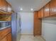 Kitchen with stainless steel refrigerator, tile floor, and dark oak cabinets at 725 N Royal Crest Cir # 213, Las Vegas, NV 89169
