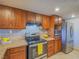 Cozy kitchen features wood cabinets, tiled backsplash, and modern stainless steel appliances at 725 N Royal Crest Cir # 213, Las Vegas, NV 89169