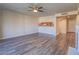 Bright living area features open layout to kitchen, ceiling fan, and modern flooring at 725 N Royal Crest Cir # 213, Las Vegas, NV 89169