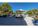 Relaxing outdoor patio with dining area, lounge seating, umbrella, and a view of the community pool at 725 N Royal Crest Cir # 213, Las Vegas, NV 89169